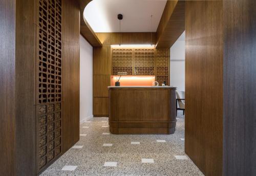 a lobby with a bar in a building with wood at Epineio Comfort Living in Litochoro