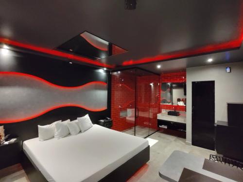a bedroom with a large bed and a bathroom at Motel Prestige in Sorocaba