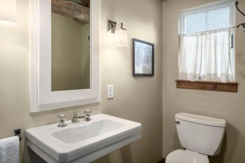 a bathroom with a white sink and a toilet at River Hill Ranch, great views & river access! in Flugrath