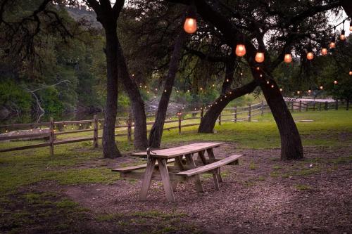 a picnic bench sitting under trees in a park at River Hill Ranch, great views & river access! in Flugrath