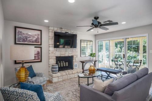 a living room with a couch and a fireplace at Rio Ranchito, Hot tub, River front, Fire Pit! in Stonewall