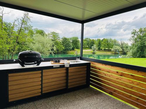 a kitchen with a large window with a grill at KOLPA - Luxury Natura House in Gradac