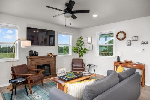 a living room with a couch and a fireplace at Cherry Pond with hot tub & spectacular VIEWS in Fredericksburg