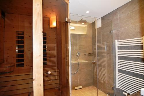 a bathroom with a shower with a glass door at Villa Alpin in Kaltenbach