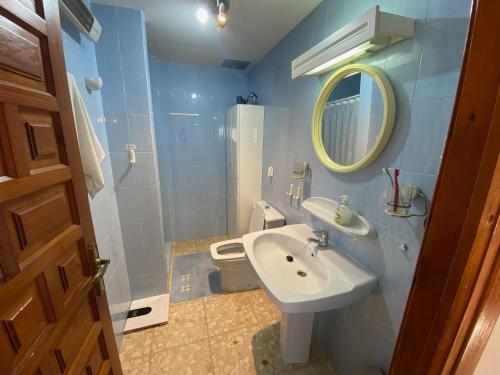 a bathroom with a sink and a toilet and a mirror at Villa Foya Blanca in Foyes Blanques