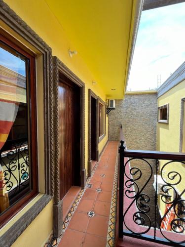 a balcony with a wrought iron railing and a window at Hotel Boutique La Casa de María Joyita in Aguascalientes