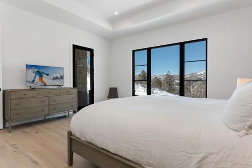 a bedroom with a large bed and large windows at 1665 Cordillera Way in Edwards