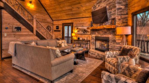 a living room with a couch and a fireplace at Hawksnest in Mashburn Mill