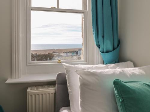 a bedroom with a window with a view of the ocean at The Old Police Station in Portland