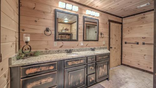 a bathroom with a sink and a mirror at Hawksnest in Mashburn Mill