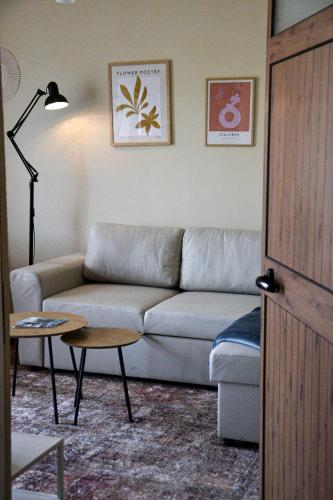a living room with a couch and a table at Shkodër A&K in Shkodër