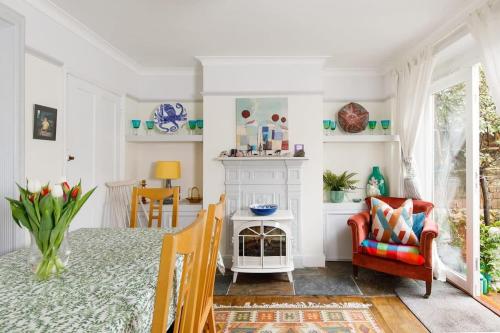 a dining room with a table and a chair at Beautiful Georgian Home in the heart of Chichester in Chichester