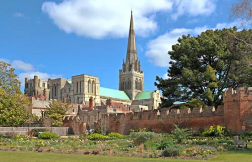 a view of a castle with a church in the background at Beautiful Georgian Home in the heart of Chichester in Chichester