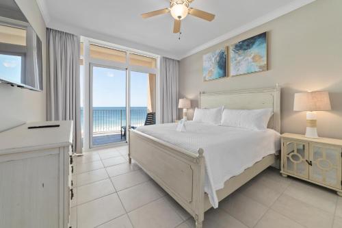 a bedroom with a bed and a view of the ocean at Luxury Gulf Front Condo Lazy River 704 in Orange Beach