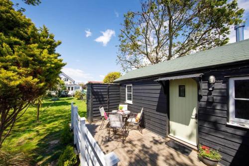 a small house with a patio and a fence at Cosy self-contained annexe in Selsey in Chichester