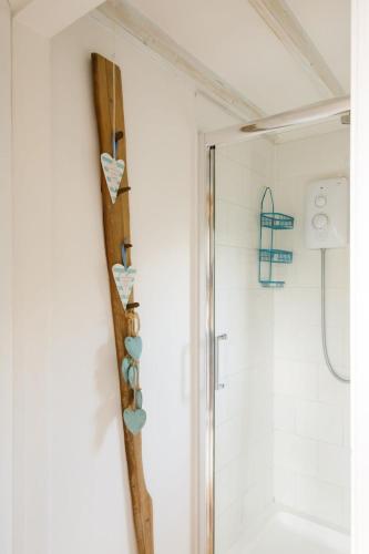 a bathroom with a shower with a wooden clipboard at Cosy self-contained annexe in Selsey in Chichester