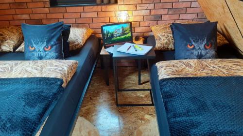 a room with two beds and a table with a night stand at Zaciszny Zakątek Zawoja in Zawoja