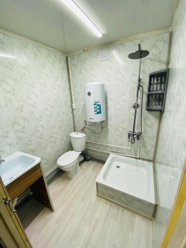 a bathroom with a shower and a toilet and a sink at Module house - Burabay in Borovoye