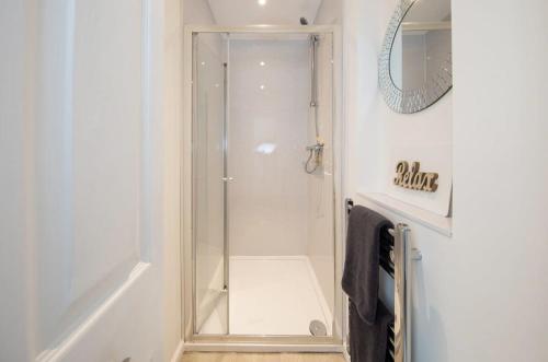 a shower with a glass door in a bathroom at Beautiful Beachfront House wth Balcony & Sea Views in Bognor Regis