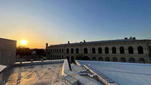 a view from the roof of a building at sunset at Mahbubakhon Guest house in old city in Bukhara