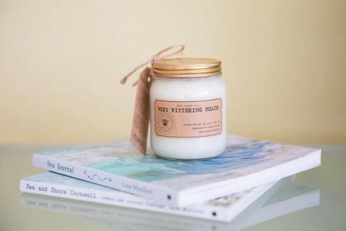 a jar of best wheats sitting on top of books at Sunny & Modern Near the Beach & Village w Parking in East Wittering
