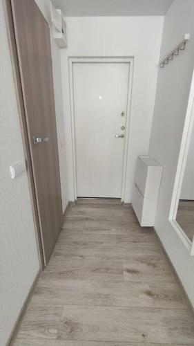 an empty hallway with a door and a hallwayngth at Light and useful stay in Kaunas