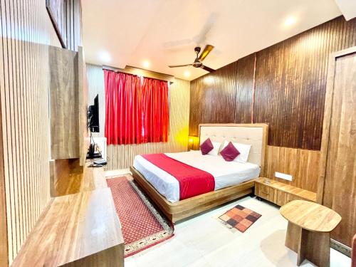 a bedroom with a bed and a red curtain at HOTEL SIDDHANT PALACE ! VARANASI fully-Air-Conditioned hotel at prime location, Lift-&-wifi-available, near-Kashi-Vishwanath-Temple, and-Ganga-ghat in Varanasi