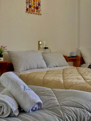 two beds sitting next to each other in a room at Alexandra Studios in Néos Pírgos