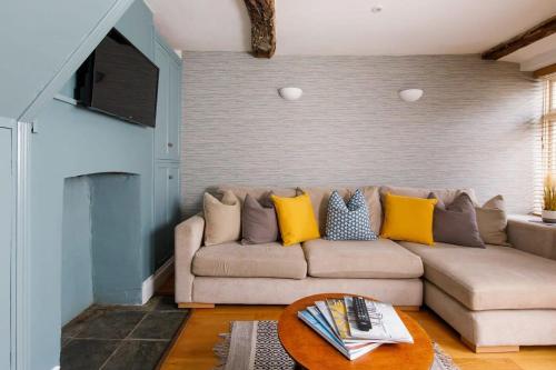 a living room with a couch and a table at Charming four-bedroom central townhouse in Chichester