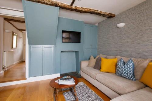 a living room with a couch and a fireplace at Charming four-bedroom central townhouse in Chichester