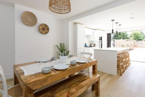 a kitchen and dining room with a wooden table at Stylish 2 Bed City Stay in Chichester