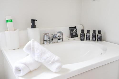 a bathroom counter with a sink with towels on it at Spacious STUDIO apt with everything you need in Los Angeles