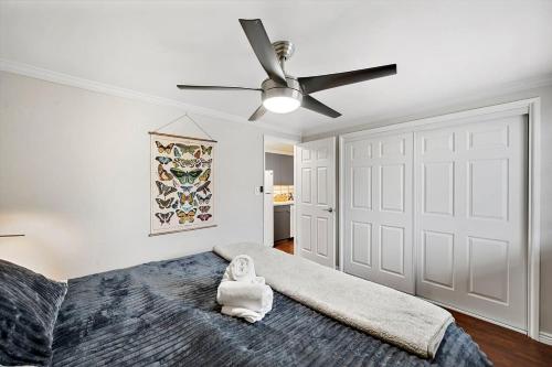 a bedroom with a bed with a ceiling fan at 1 1 Bright Corner Unit Walkability & Close to Hospitals in Englewood