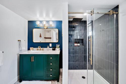 a bathroom with a green cabinet and a shower at Stylish 2 Bedroom Apt Steps From Regis Tennyson St in Denver