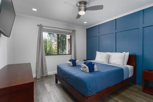 a blue bedroom with a bed and a window at Remodeled Corner Unit 2 2 Overlooking the Lagoon in Hilton Head Island