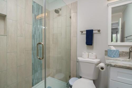 a bathroom with a toilet and a glass shower at Remodeled Corner Unit 2 2 Overlooking the Lagoon in Hilton Head Island