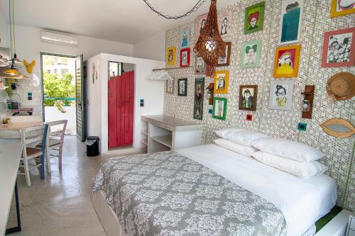 a bedroom with a bed and a wall of pictures at Pefkos Eye in Pefki Rhodes
