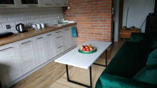 a bowl of apples on a table in a kitchen at Domek z kominkiem, Ukta 63, Mazury, in Ruciane-Nida