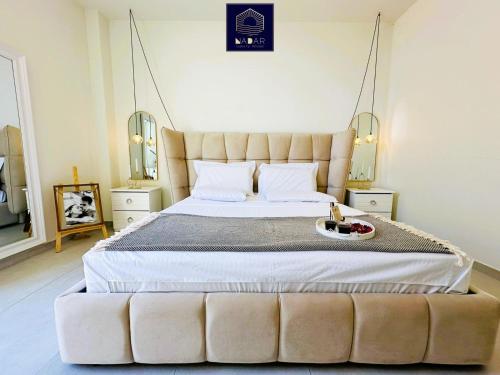 a bedroom with a large bed with a tufted headboard at NaDar Luxury House - Green Coast in Himare