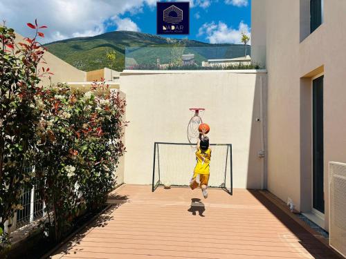 a young girl is playing on a hoop at NaDar Luxury House - Green Coast in Himare