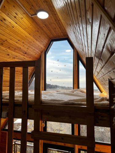 a view from the inside of a tree house with a window at ECO PARK ASPAN in Almaty