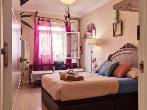 a bedroom with a large bed and pink curtains at Begutxi LVI00061 in Vitoria-Gasteiz