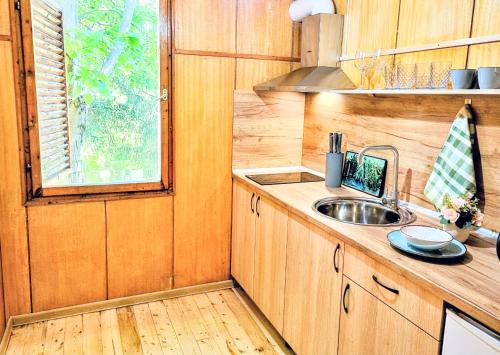 a small kitchen with a sink and a window at Къмпинг и Бунгала Брусен Хил - Camping and Bungalows Brusen Hill 