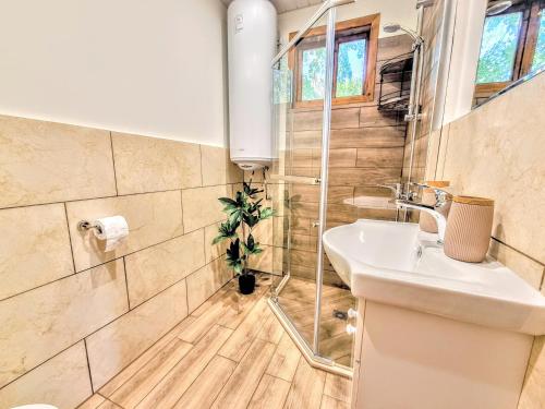 a bathroom with a sink and a shower at Къмпинг и Бунгала Брусен Хил - Camping and Bungalows Brusen Hill in Brusen