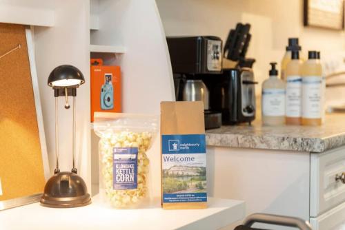 a counter top with a box of popcorn and wine bottles at NN - The Evelyn - Whistlebend 1-bed 1-bath in Whitehorse