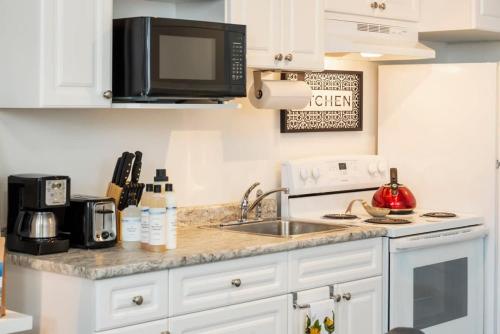a kitchen with a sink and a microwave at NN - The Evelyn - Whistlebend 1-bed 1-bath in Whitehorse