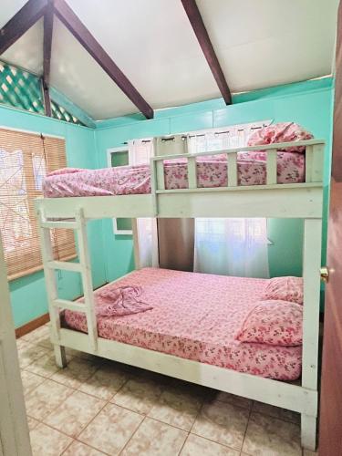 a bedroom with two bunk beds in a room at Casa Rio in Cocles