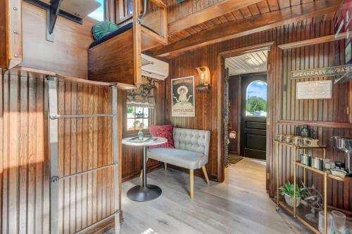 a room with wooden walls and a table and a chair at 1920s Red Rock Caboose Bike Hike Explore in Colorado Springs