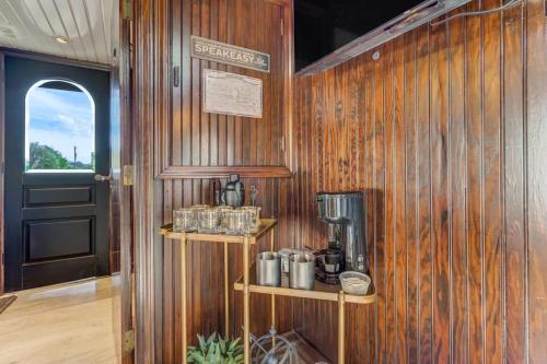 a room with a wooden wall with a coffee maker at 1920s Red Rock Caboose Bike Hike Explore in Colorado Springs