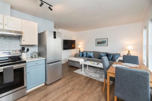 a kitchen and living room with a couch and a table at NN - The Summit - Copper Ridge 1-bed 1-bath in Whitehorse
